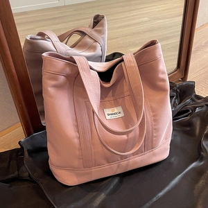 Spacious light pink canvas tote bag with shoulder straps and SHANGCAI logo for daily commute