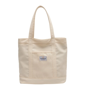 Minimalist off-white canvas tote bag with shoulder straps for daily commuting