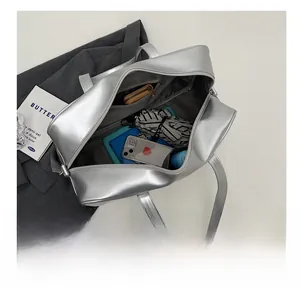 Detail view of large silver tote bag interior showing spacious storage for daily essentials