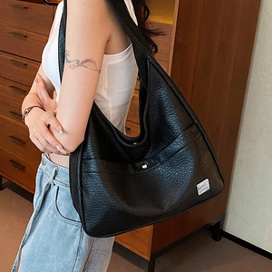 Black large capacity hobo shoulder bag with pebble grain texture and metal detail