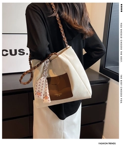 Detail of cream canvas tote bag with heart embossed pattern and woven strap
