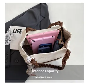 Top view of cream tote bag internal capacity showing storage for tablets and phones