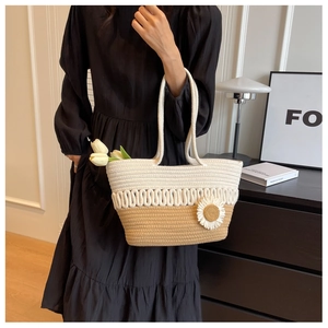 Detailed weave pattern on tote bag with a 3D daisy flower and rope handle strap