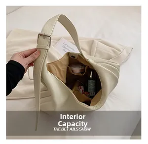 Internal capacity of the beige pebble leather tote showing spacious storage for cosmetics