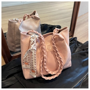 Pink heart embossed tote bag with woven handles and silk scarf detail on silk fabric