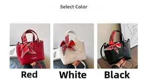 Detailed view of fashion bucket bags in red, white and black with silk bow decoration
