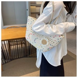Detailed texture of white woven tote bag with colorful dots and floral accent