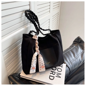 Detail of black canvas tote bag with silk scarf and Fashion & Bag EST 1985 text
