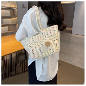 Detailed texture of woven tote bag with colorful polka dots and sunflower ornament