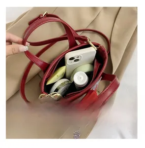 Top view of red bucket bag interior showing capacity for phone and cosmetics