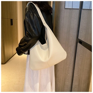 Minimalist beige large capacity tote bag shown on shoulder for a slouchy hobo style