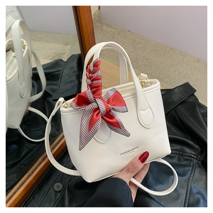 White leather mini tote bag with red checkered bow and mirror reflection detail
