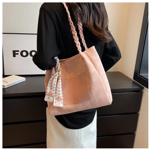 Pink heart-textured canvas tote bag with woven shoulder straps and decorative scarf
