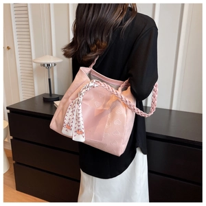 Pink heart-embossed tote bag with woven handles and silk scarf detail on shoulder