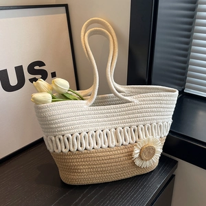 Handwoven two-tone straw tote bag with sunflower detail and dual rope handles