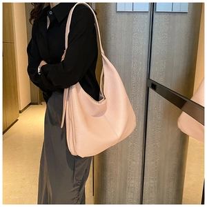 Close-up of pink large capacity hobo bag showing soft lychee grain texture and minimalist design