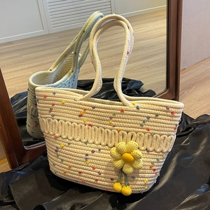 Handwoven cream tote bag with colorful polka dots and a yellow crochet flower charm