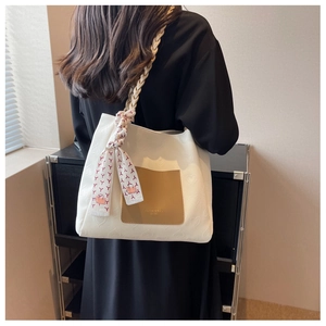 Detail of canvas tote bag with heart embossing and leather pocket for daily commute