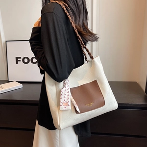 White canvas tote bag with heart embossing and brown woven handles for women