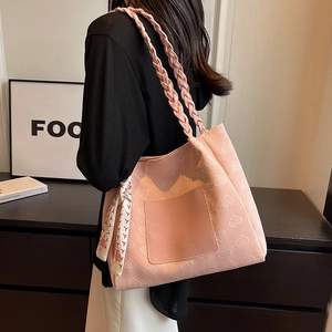 Pink canvas tote bag with heart embossed pattern and braided handle for women