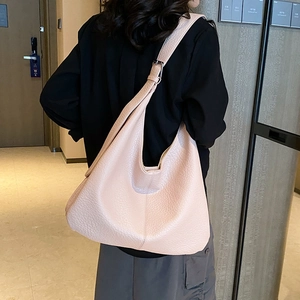 Large apricot leather hobo bucket bag with adjustable shoulder strap and pebble texture