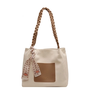 Creamy white canvas tote bag with heart embossed texture and brown accent handles