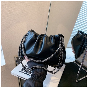 Detailed view of black cloud bag with gathered faux leather and chunky silver chain