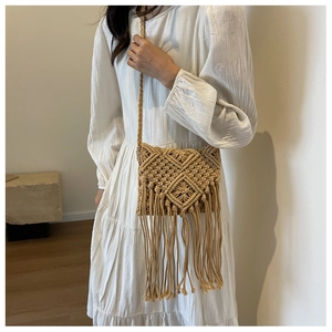 Detailed Macramé weave pattern and long fringe tassels on a summer straw crossbody bag