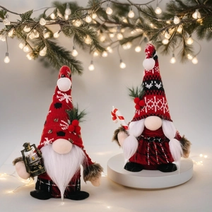 Christmas gnomes set with red knitted hats holding a lantern and candy cane in holiday decor