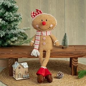 Detailed view of gingerbread doll with waffle texture sitting on a wooden bench