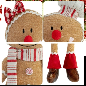 Detail view of gingerbread plush toy with chef hat, striped scarf and candy buttons