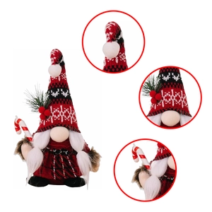 Detail of Christmas gnome plush doll with red snowflake hat and candy cane decoration