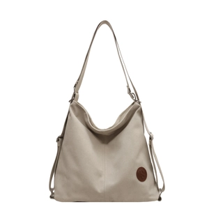 Sac fourre-tout minimaliste en toile beige avec logo en cuir et bandoulière