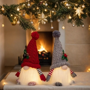 Close-up of glowing LED Christmas gnomes with knitted hats and warm festive lights