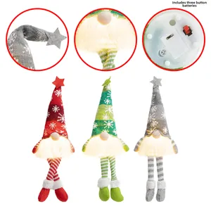 Close-up of three LED Christmas gnomes showing battery compartment and light-up textures