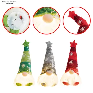 Detail of three LED glowing Christmas Gnomes with battery compartment and star caps