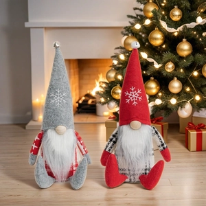 Close-up of Christmas gnomes with snowflake embroidery and bells on tall pointed hats