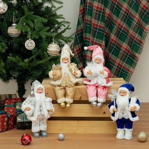 Detail of 12-inch sitting Santa figurines in champagne, pink, white, and blue velvet suits