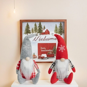 Detail of red and grey Christmas gnomes featuring snowflake embroidery and long faux fur beards