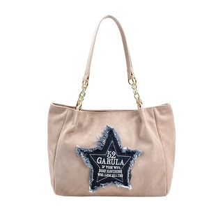 Large beige suede tote bag with blue denim star patch and gold chain shoulder strap