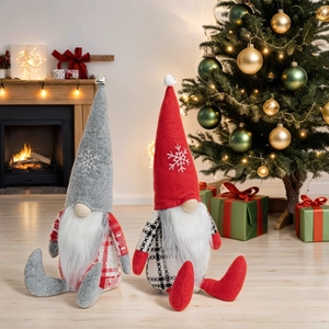 Detailed view of plush Christmas gnomes with snowflake embroidery in a cozy home setting