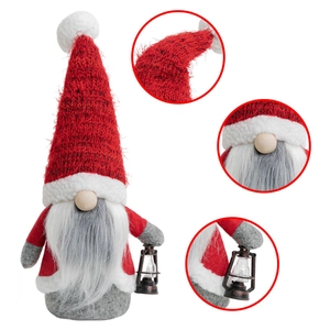 Detail of Christmas gnome showing knitted red hat texture, white beard and vintage lantern