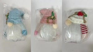 Detailed view of Christmas gnomes in blue, pink, and white plush with knit hats