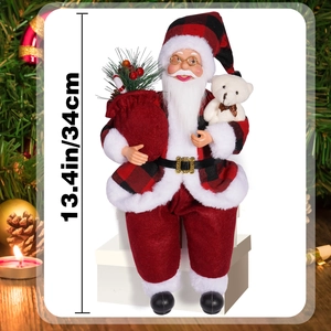 Detail of 13.4-inch Santa Claus figurine holding a gift bag and white teddy bear