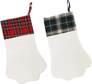 Detail of pet paw Christmas stockings featuring red and green plaid patterns on soft plush