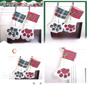 Close-up of Christmas pet paw stockings in red and green plaid fabric for holiday decor