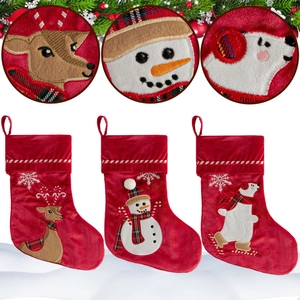 Three red velvet Christmas stockings featuring reindeer, snowman, and polar bear embroidery