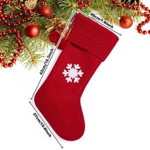 Macro detail of red knitted Christmas stocking with white snowflake and 42cm size markings