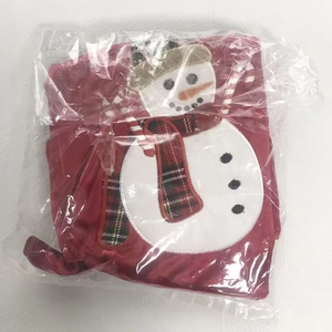 Detail of red Christmas clothing in packaging featuring a festive snowman embroidery