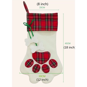 Plaid dog paw shaped Christmas stocking with bone charms and green ribbon bow